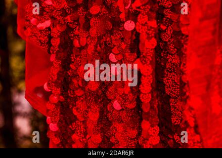 Red sequins pattern. Sparkling sequins background. Red sequin fabric for background. rectangular red shiny fabric with sequins, Christmas background. Stock Photo