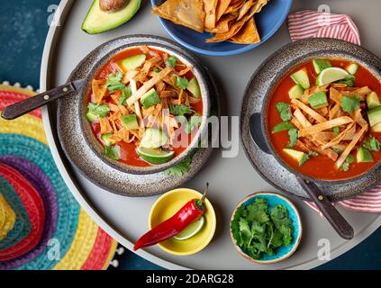Mexican style table with spicy aztec soup with tortilla. Copy space Stock Photo