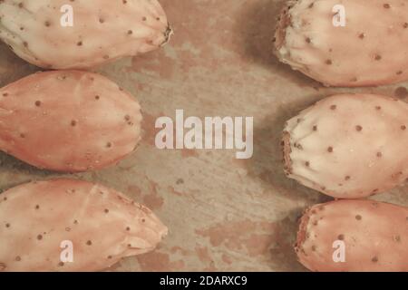 Prickly pear cactus fruits opuntia figs top view on rusted shabby metal background with space for text. Stock Photo