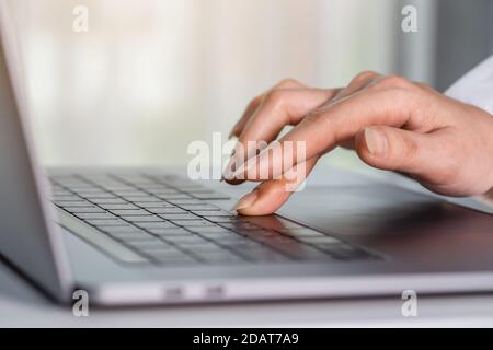 close-up female hand pressing space bar button on a laptop keyboard Stock Photo