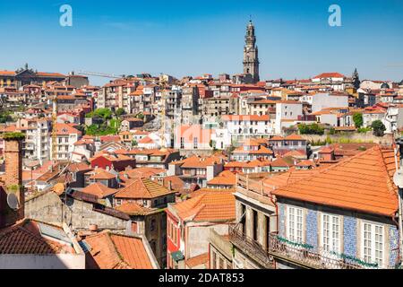 View across the tiled roofs of Porto, Portugal, on a fine spring day. The skyline is dominated by the tower of the Igreja dos Clérigos, the Church of Stock Photo