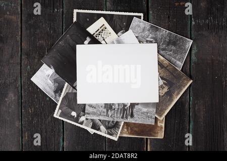 Old black and white photographs on a wooden background lined with a stack, blank empty templates, mock-up. Stock Photo