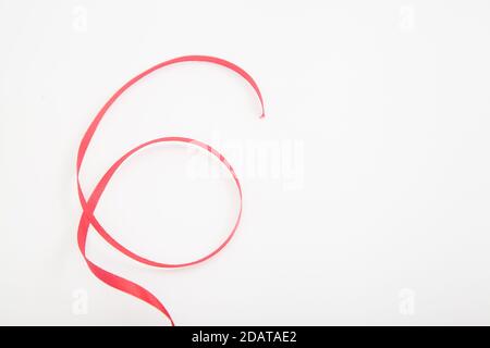 Curved red wavy ribbon on white in shape of number 6 with space Stock Photo