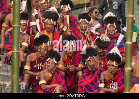 Naga tribesmen  wearing their traditional attire and siting together in Kisama Village arena  in Nagaland India on 4 December 2016 Stock Photo