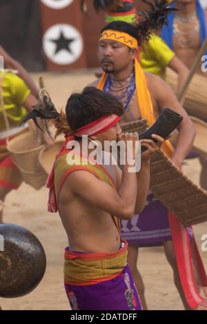 Tribal boys of Nagaland playing their folk musical instruments and performing traditional dance at Kisama village nagaland India on 4 December 2016 Stock Photo