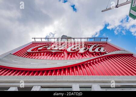 A daytime close up of the giant Coca Cola billboard sign at the top of William Street in Kings Cross, Sydney was erected in 1971 and refurbed in 2016 Stock Photo