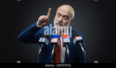 Politician giving a speech during the election campaign, he is gesturing and talking to the media Stock Photo