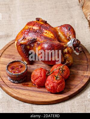 Chicken baked in the oven with tomatoes and sauce Stock Photo