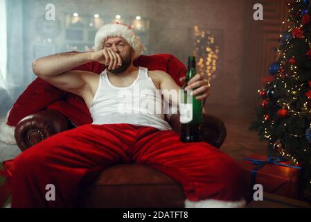 Bad Santa claus takes drugs with alcohol, humor Stock Photo