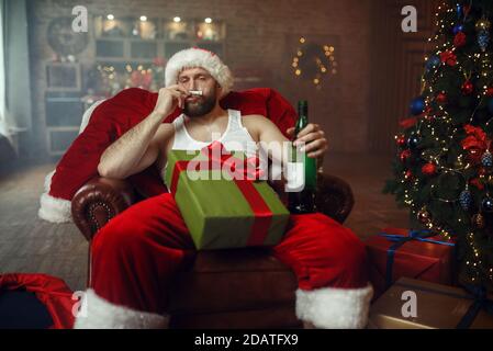 Bad Santa claus takes drugs with alcohol, humor Stock Photo