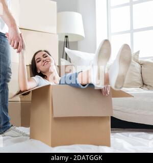 young family unpacking boxes in their new apartment Stock Photo