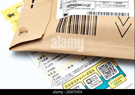 Amazon Japan kraft bubble mailer padded envelope with delivery notice from Japanese company Yamato Transport. Stock Photo