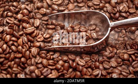 Close up of seeds of coffee. Fragrant coffee beans are roasted smoke comes from coffee beans. Stock Photo