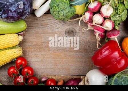 Vegetable background with blank space in the center. Healthy eating. Harvesting concept. Space for text. Top view. Stock Photo