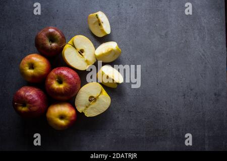 Red and yellow apples on a table. Grey background with copy space. Healthy eating concept. Stock Photo