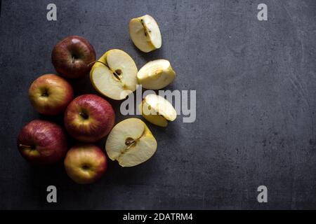 Red and yellow apples on a table. Grey background with copy space. Healthy eating concept. Stock Photo