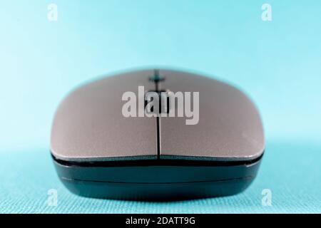 Wireless computer mouse on a blue background. Modern computer technologies. Stock Photo