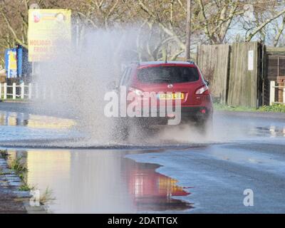 Sheerness, Kent, UK. 15th November, 2020. UK Weather: motorists contend with a flooded road after heavy rain this morning in Sheerness, Kent.  Credit: James Bell/Alamy Live News Stock Photo