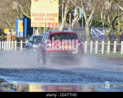 Sheerness, Kent, UK. 15th November, 2020. UK Weather: motorists contend with a flooded road after heavy rain this morning in Sheerness, Kent.  Credit: James Bell/Alamy Live News Stock Photo