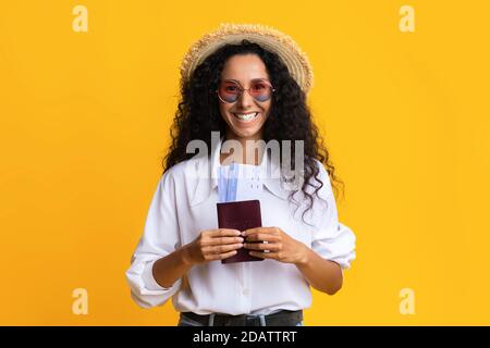 Happy Brunette Woman In Stylish Hat And Sunglasses Holding Pasport And Tickets Stock Photo