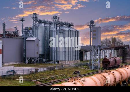 Grain silo, warehouse or depository next to railroad tracks Stock Photo