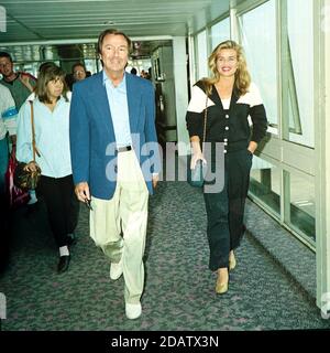 Des O'Connor with his wife Jodie Brooke Wilson at London Heathrow Airport 1992 Stock Photo