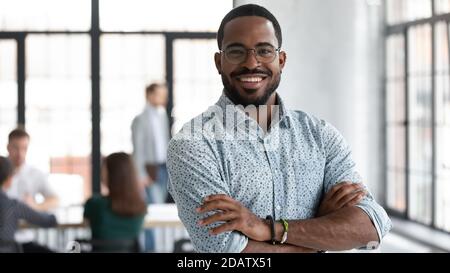 Confident black leader standing at modern company office feeling proud Stock Photo