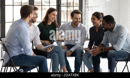Friendly female trainer praising black male trainee for correct answer Stock Photo