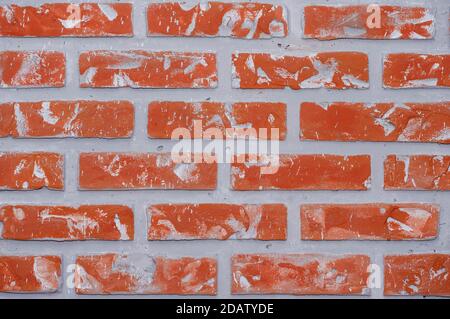 Bright red clay bricks wall flat background texture pattern Stock Photo