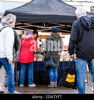 London UK, November 15 2020, Group Of People Waiting In Line Or Queuing At A Vegan Market Stall during COVID-19 Coronavirus Lockdown Stock Photo