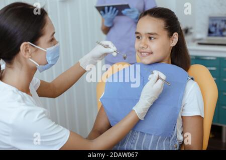 Dentist doing professional teeth cleaning and dental services Stock Photo