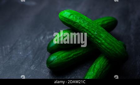 Mini green cucumber on a dark background Stock Photo