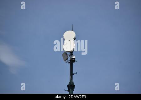 wireless surveillance camera mounted on high tower Stock Photo