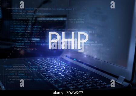PHP inscription against laptop and code background. Learn php programming language, computer courses, training. Stock Photo