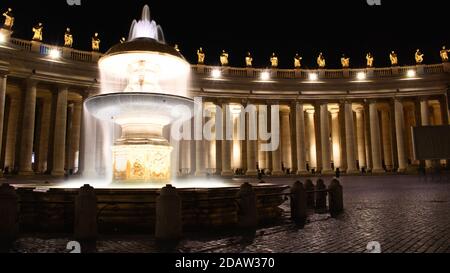 The Fontana del Bernini in St. Peter's Square in the Vatican at night Stock Photo