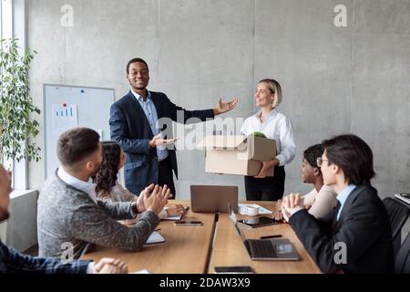 Businessman Introducing New Team Member During Corporate Meeting In Office Stock Photo