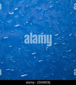Water drops on dark textured surface. Abstract background. Natural pattern close up photo. Macro photo of water drops. Stock Photo