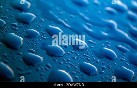 Water drops on dark textured surface. Abstract background. Natural pattern close up photo. Macro photo of water drops. Stock Photo