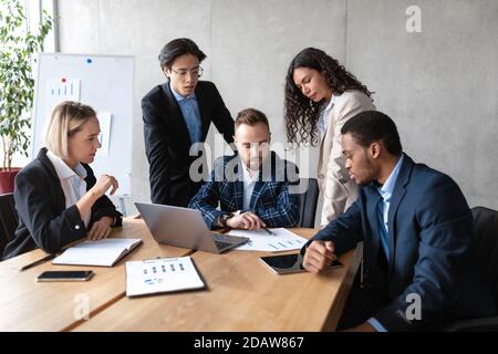 Serious Diverse Business Team Working At Laptop In Office Stock Photo