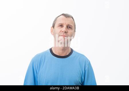 Surprised middle aged man. Shocked middle aged man looking surprised with wide open eyes isolated white wall background. Human Emotions Stock Photo