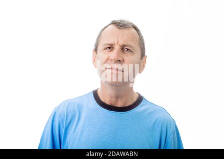 Perplexed middle age man feeling grumpy over white background. Portrait of irriated middle age man looking very displeased isolated on white backgroun Stock Photo