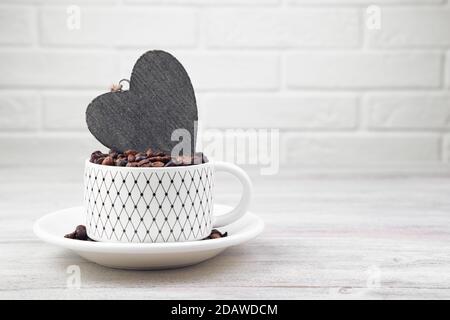 Coffee background with coffee beans in a Cup and candles on a light cozy background with space for copying. Stock Photo