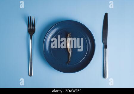 Salted dried fish on plate. Stock Photo