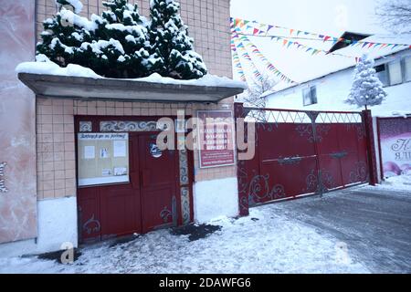 Main entrance, gate, to the Klavdievo toys factory, Christmas trees over doors Stock Photo