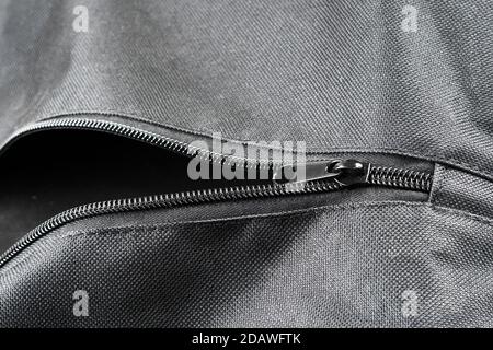 closeup shot of a black zipper  on a black leather jacket. Stock Photo