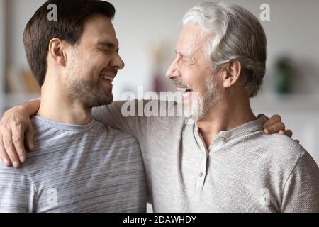 Close up overjoyed mature father with son laughing, having fun Stock Photo
