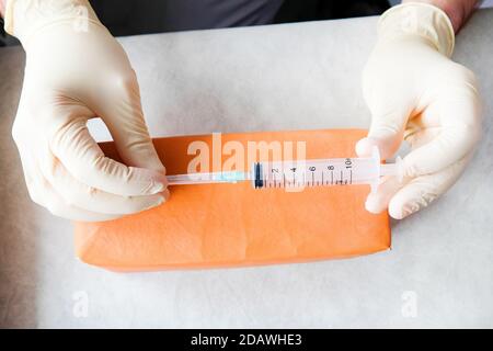 The nurse is holding an empty syringe. View from above. Stock Photo