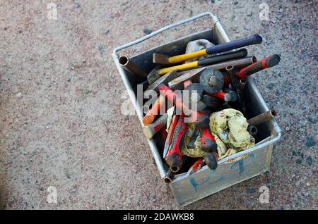 Mining tools and equipment in a metal box on the grey  ground. Stock Photo
