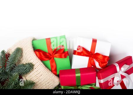 Christmas stocking red and white knitted handmade woolen sock fir tree and gifts isolated on white background Stock Photo