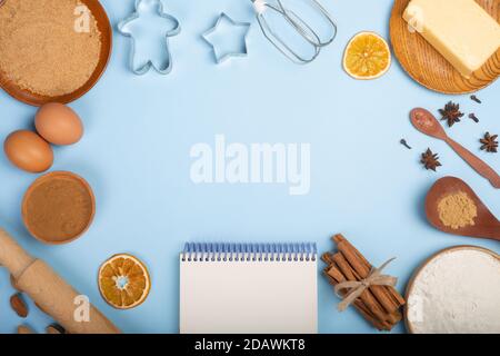 Christmas gingerbread cookies cooking background flat lay top view template with copy space for text. Baking utensils, spices and food ingredients on Stock Photo